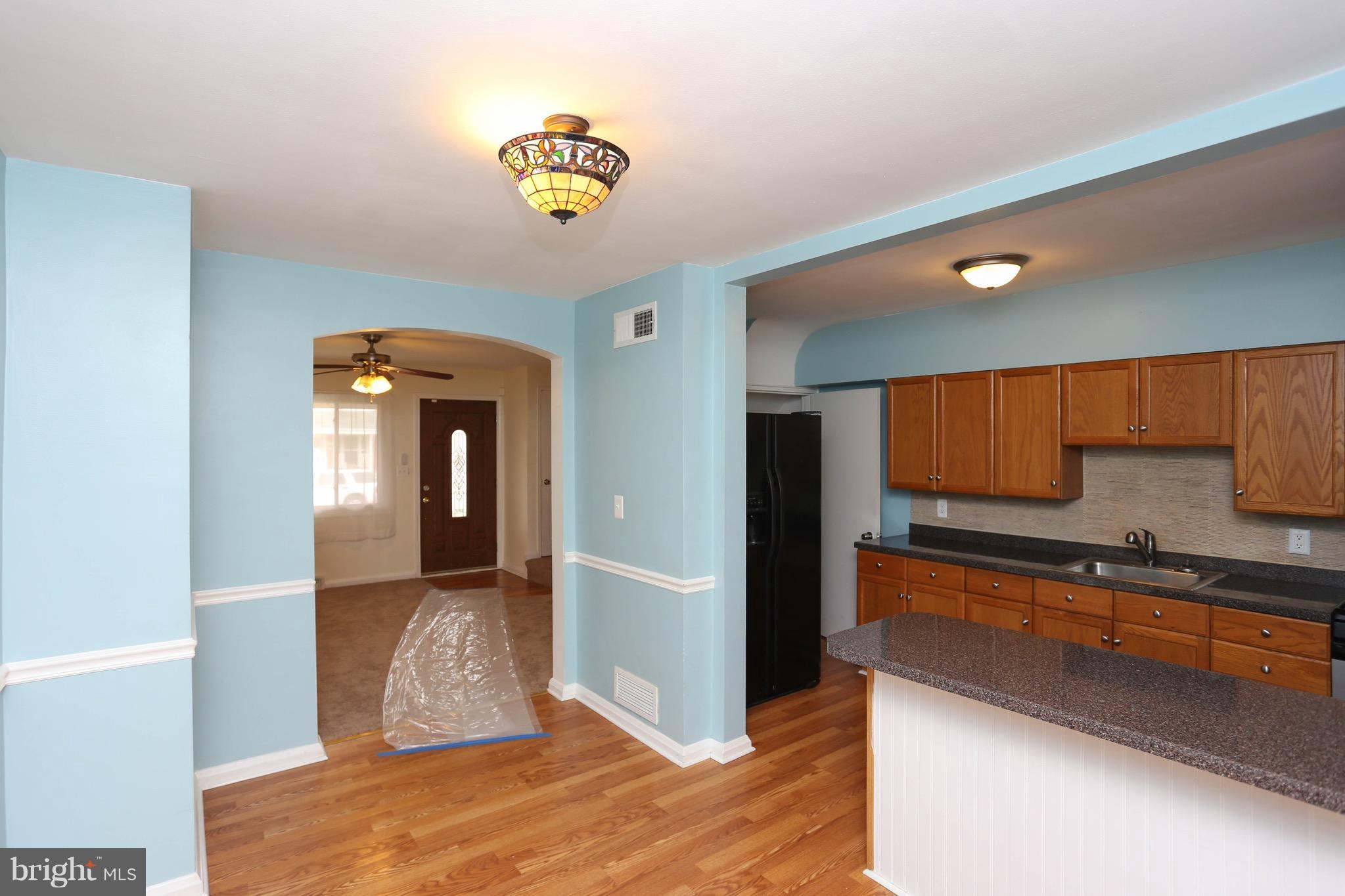 1957 Holborn Road Baltimore, MD 21222 - Photo 6 of 25 a kitchen with kitchen island granite countertop a refrigerator and a sink