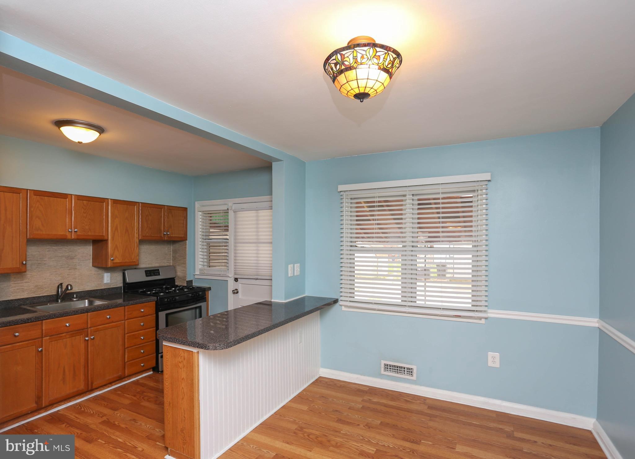 1957 Holborn Road Baltimore, MD 21222 - Photo 7 of 25 a kitchen with a window appliances and cabinets