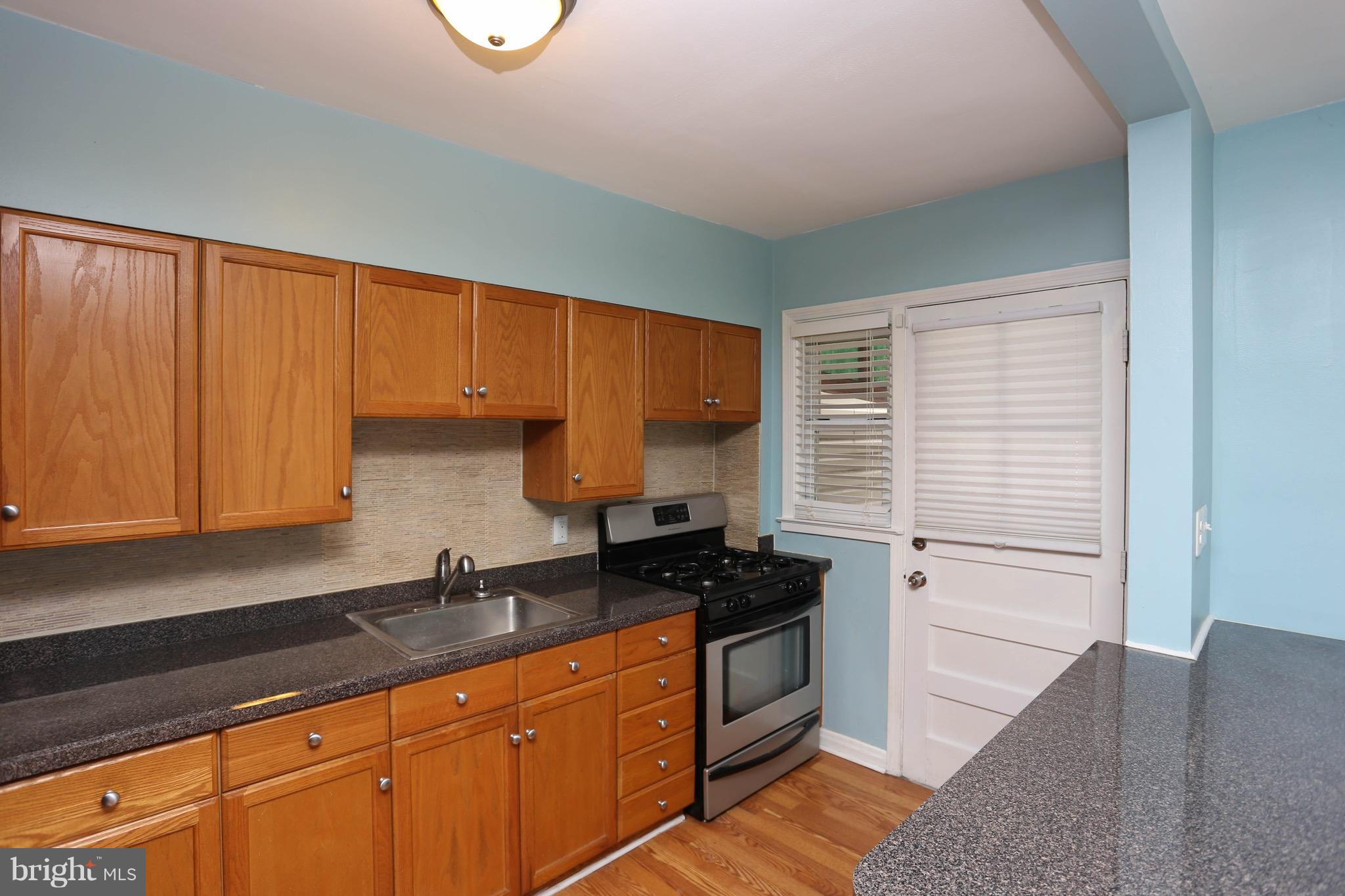 1957 Holborn Road Baltimore, MD 21222 - Photo 8 of 25 a kitchen with stainless steel appliances granite countertop a stove a sink and a microwave