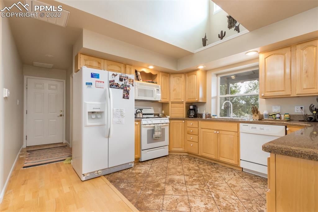 6670 Zercher Road Beulah, CO 81023 - Photo 16 of 41 a kitchen with a refrigerator sink and cabinets