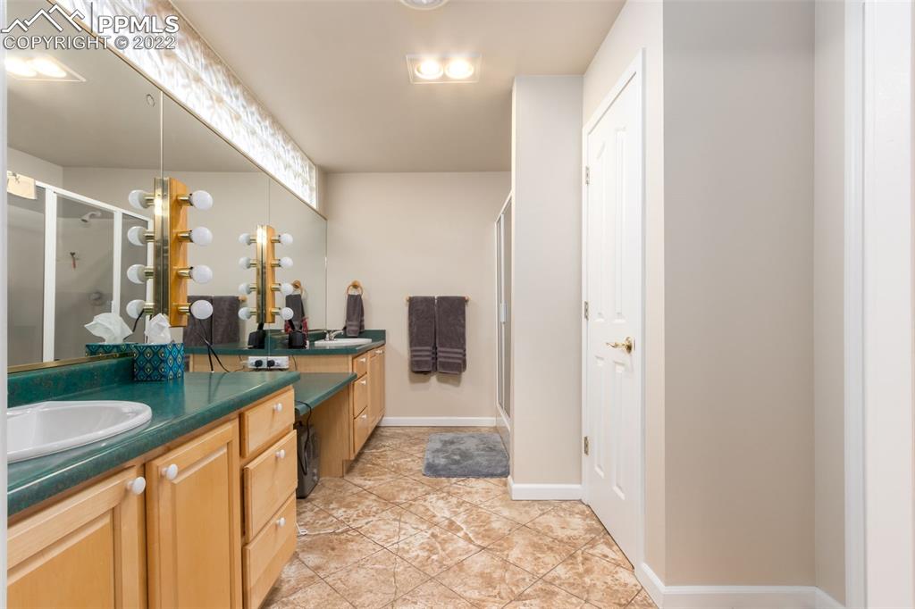 6670 Zercher Road Beulah, CO 81023 - Photo 24 of 41 a large bathroom with a granite countertop sink and a mirror