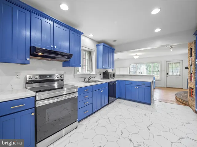 a kitchen with stainless steel appliances granite countertop a stove cabinets and sink