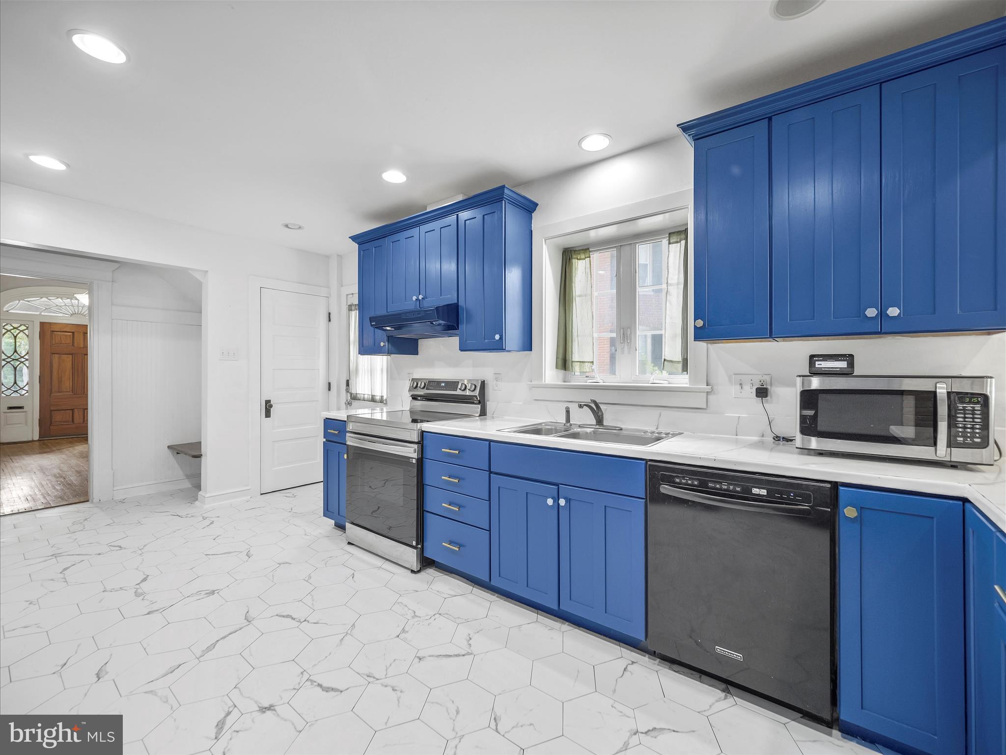 223 East 3rd Street Waynesboro, PA 17268 - Photo 13 of 42 a kitchen with kitchen island granite countertop wooden cabinets stainless steel appliances a sink and a window