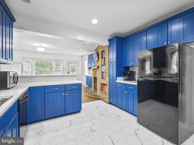 a kitchen with stainless steel appliances granite countertop a refrigerator sink and cabinets