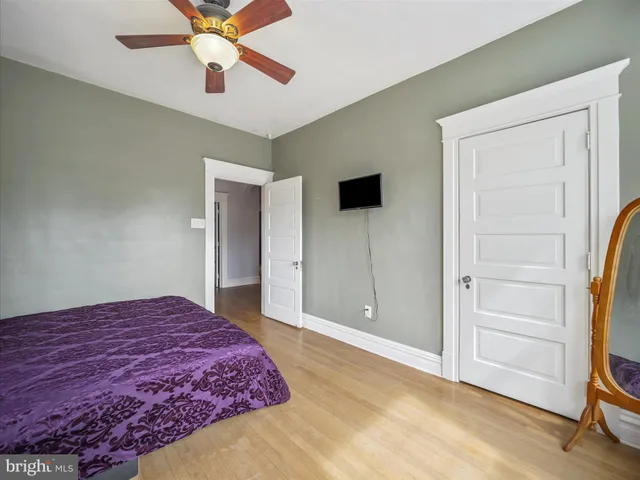 a spacious bedroom with a bed and a chandelier