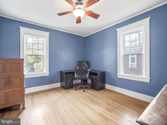 a workspace room with furniture and window