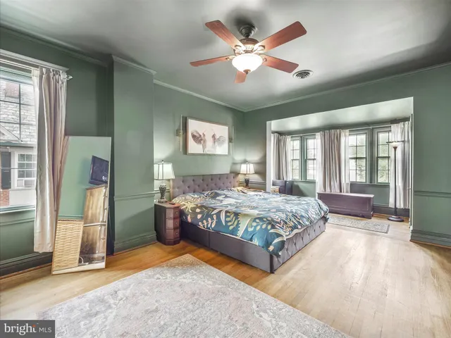 a bedroom with a large bed and a chandelier