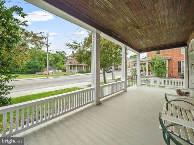 a view of a room with wooden floor and iron stairs