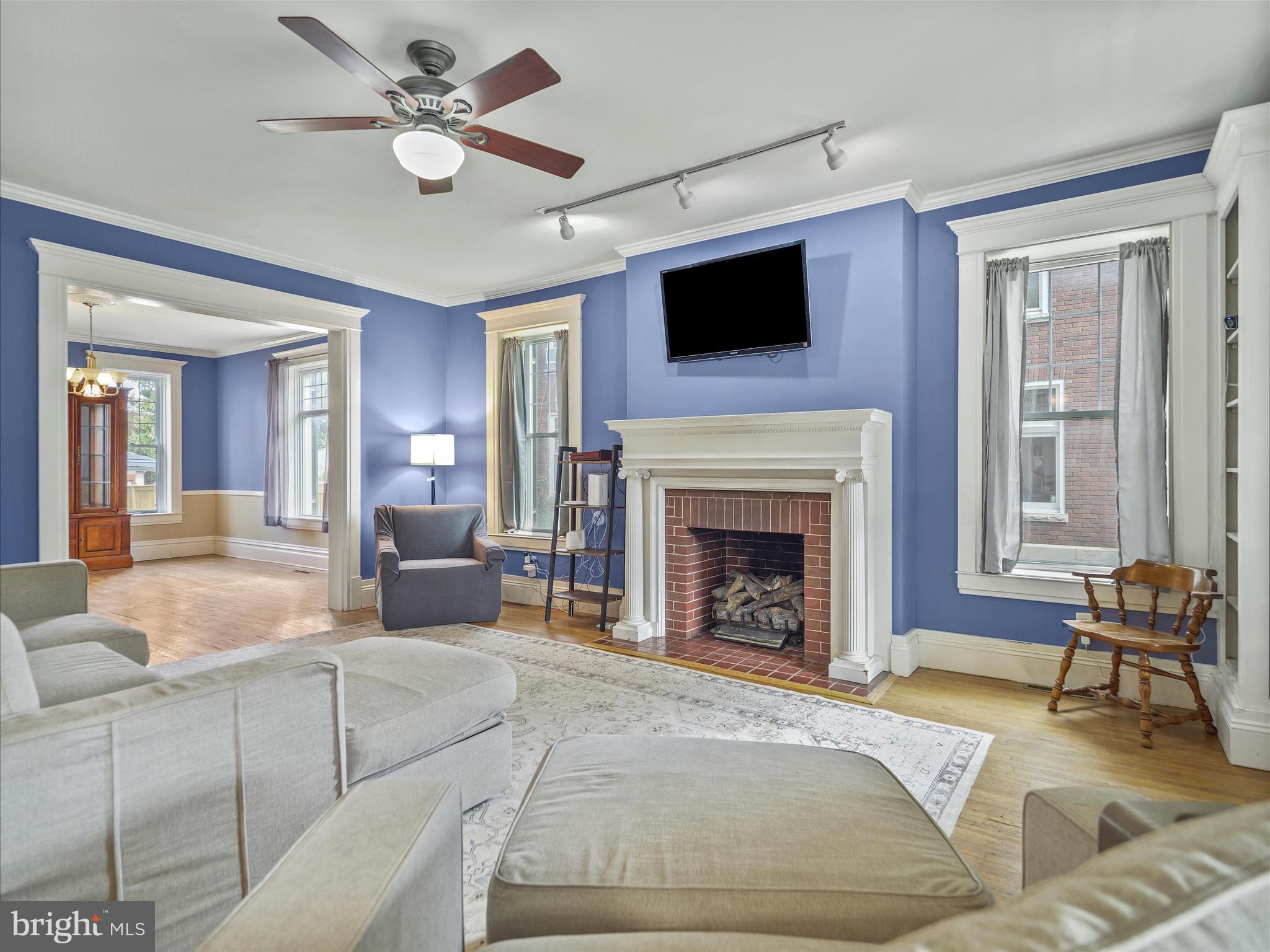 223 East 3rd Street Waynesboro, PA 17268 - Photo 6 of 42 a living room with furniture a fireplace and a flat screen tv
