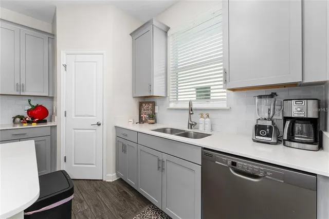 a kitchen with a sink cabinets and window