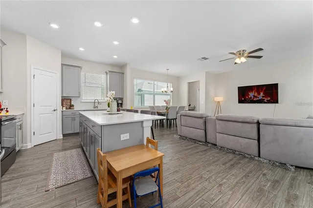 a kitchen with a sink cabinets and wooden floor