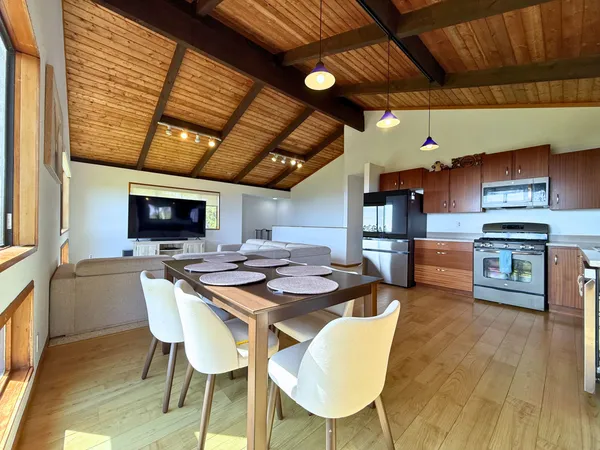 a view of a dining room with furniture and wooden floor