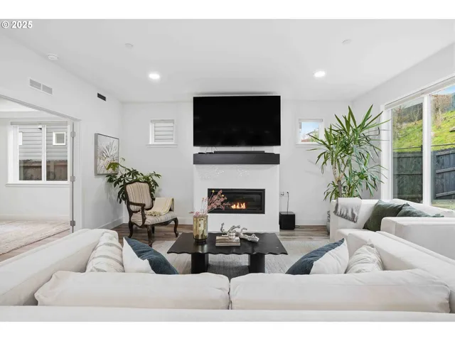 a living room with furniture fireplace and a flat screen tv