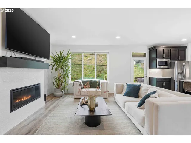 a living room with furniture a fireplace and a flat screen tv