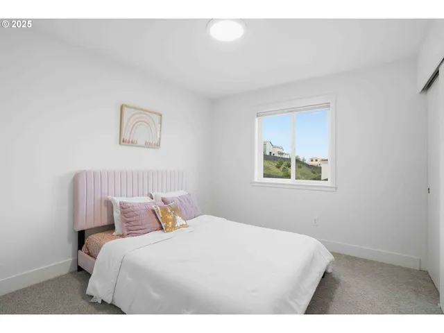 a bedroom with a bed and a lamp