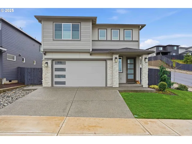 a front view of a house with a yard and garage