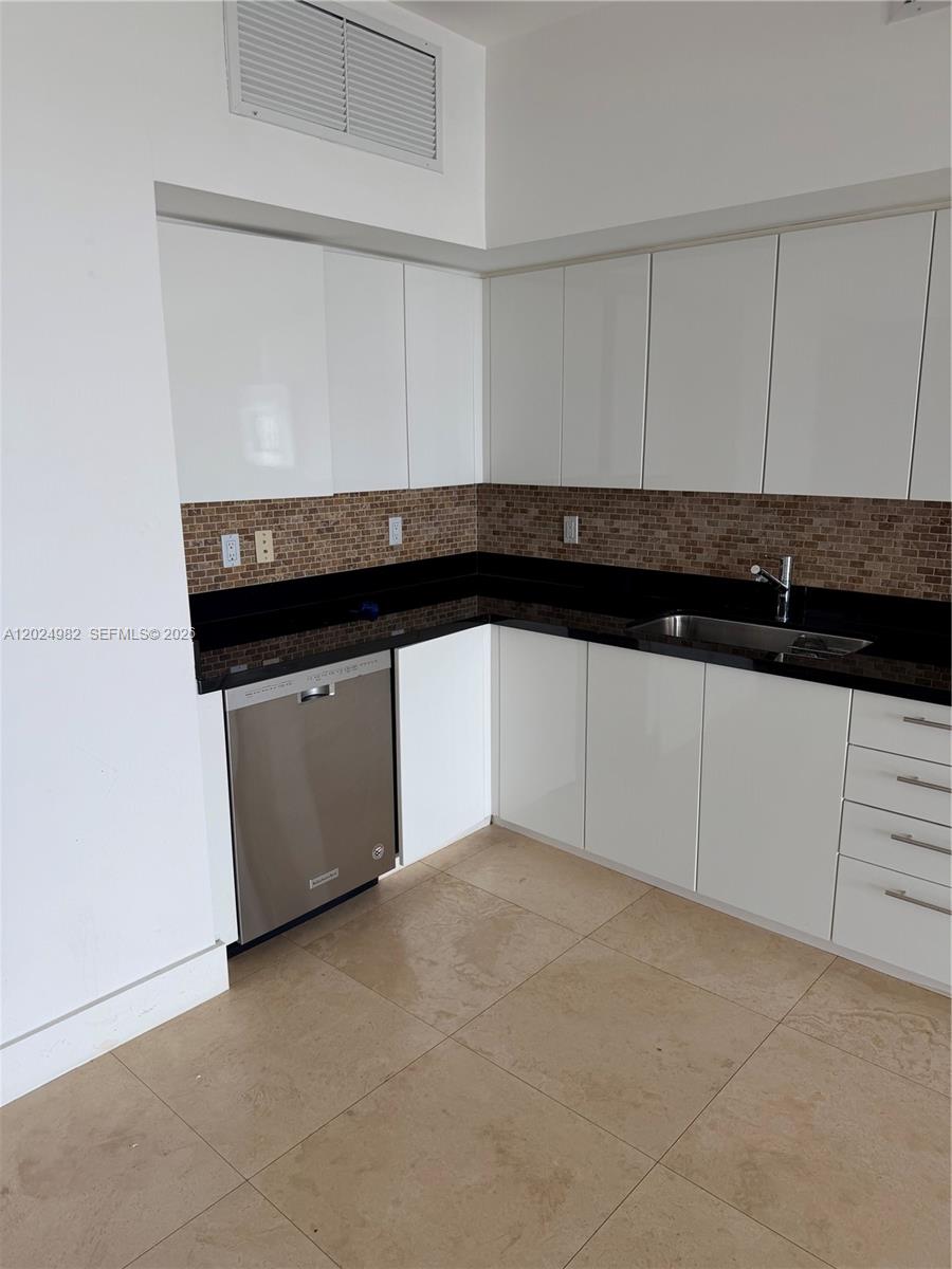 92 Southwest 3rd Street, Unit 3909 Miami, FL 33130 - Photo 13 of 13 a kitchen with granite countertop white cabinets and a sink