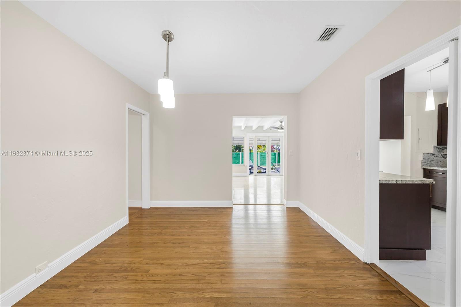 340 Southwest 25th Road Miami, FL 33129 - Photo 11 of 42 a view of empty room with wooden floor and fan
