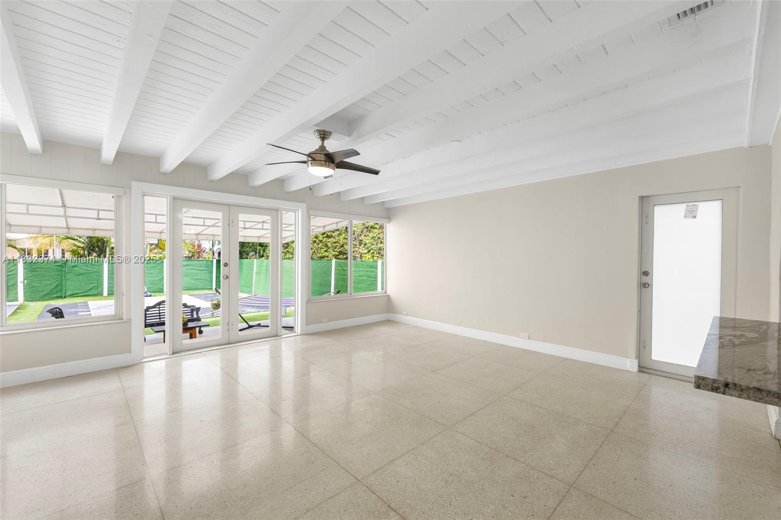 340 Southwest 25th Road Miami, FL 33129 - Photo 17 of 42 a view of an empty room with windows and wooden floor