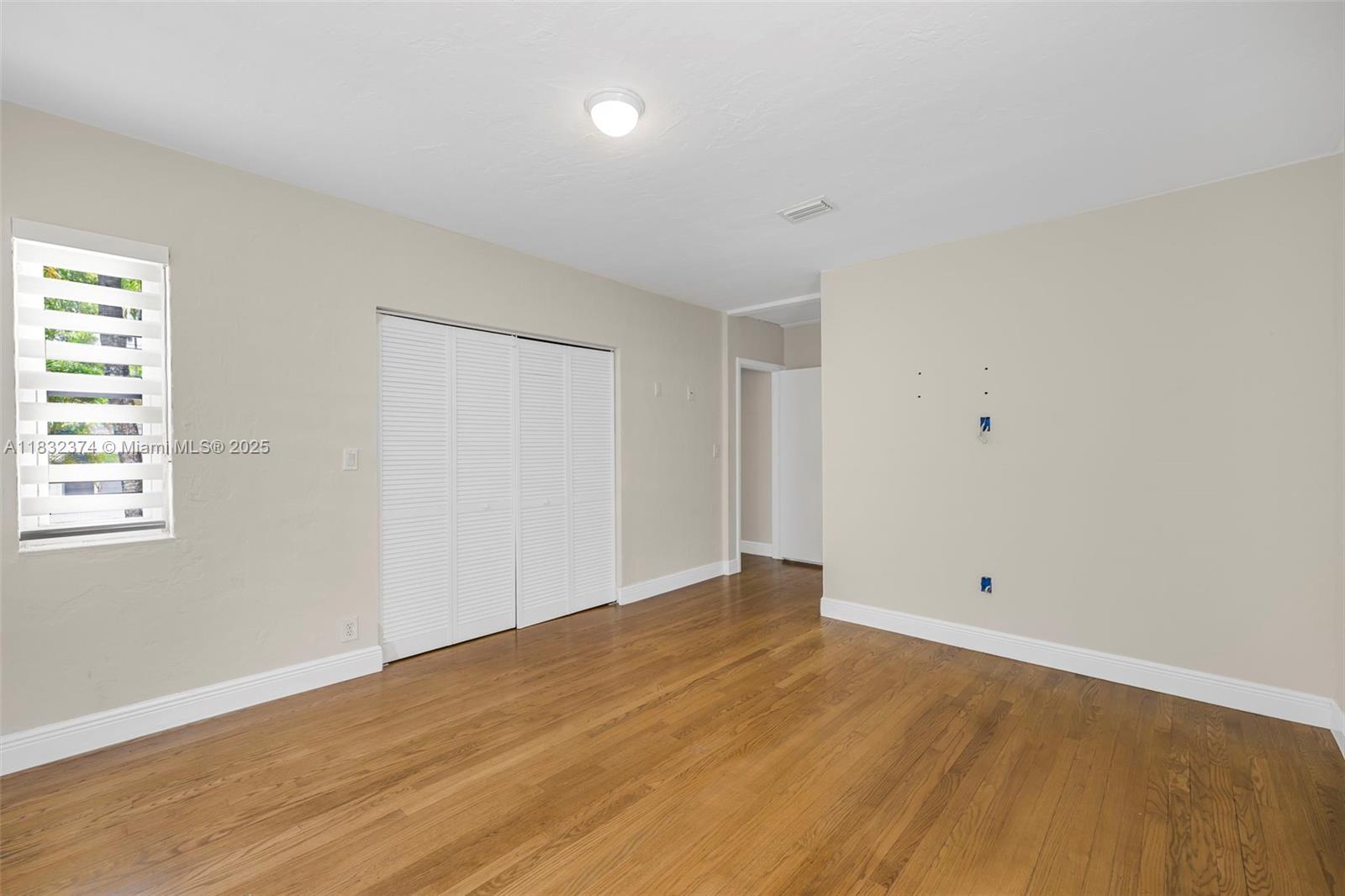 340 Southwest 25th Road Miami, FL 33129 - Photo 22 of 42 a view of an empty room with wooden floor