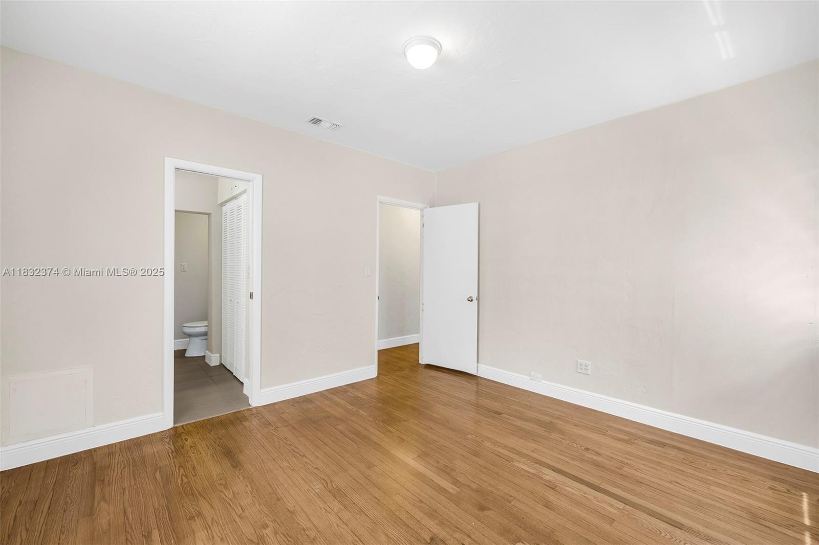 340 Southwest 25th Road Miami, FL 33129 - Photo 23 of 42 a view of an empty room with wooden floor