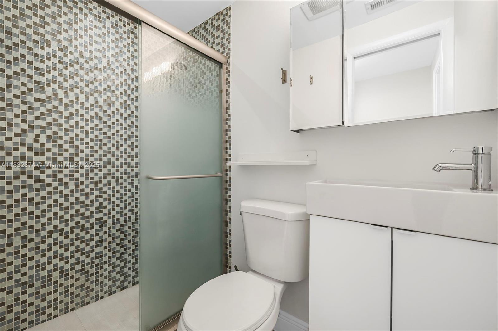 340 Southwest 25th Road Miami, FL 33129 - Photo 26 of 42 a white toilet sitting next to a bathroom sink