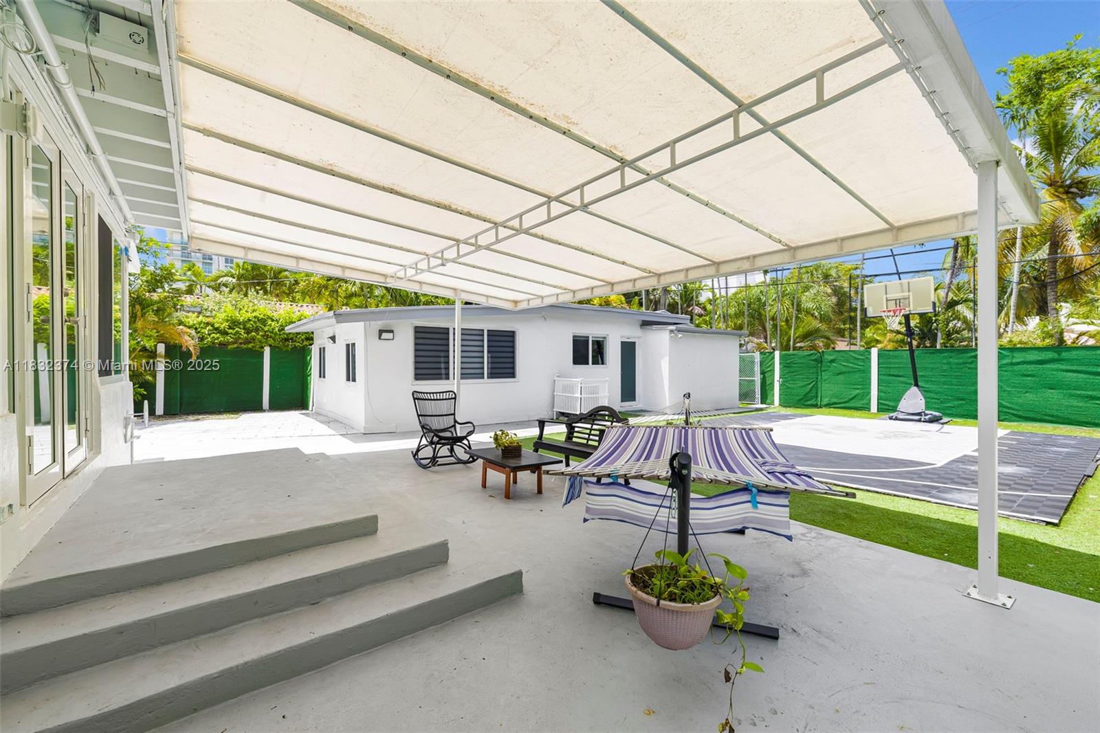 340 Southwest 25th Road Miami, FL 33129 - Photo 30 of 42 a view of a patio with couches and table and chairs under an umbrella