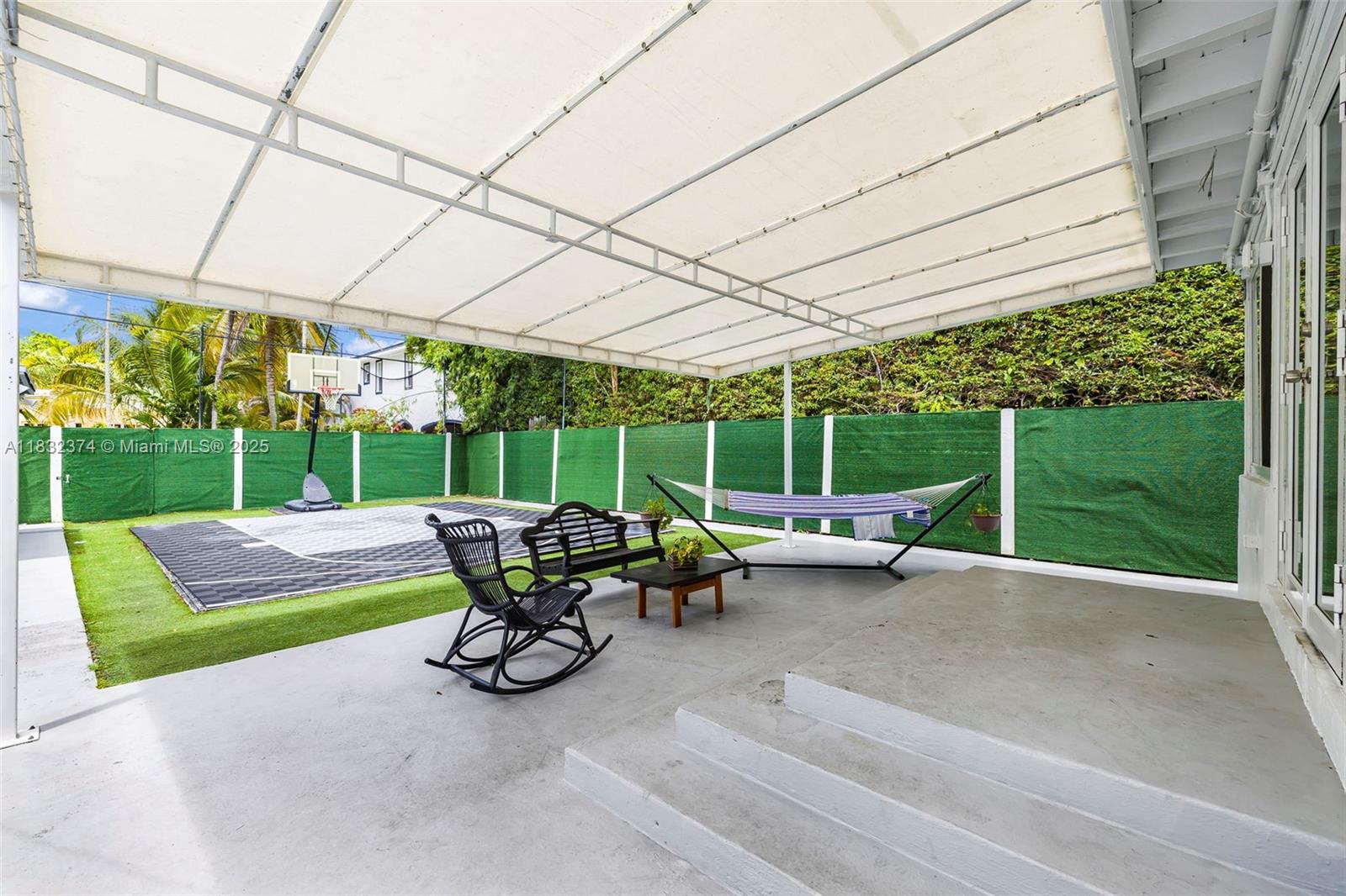 340 Southwest 25th Road Miami, FL 33129 - Photo 31 of 42 a view of a patio with a table chairs and a yard