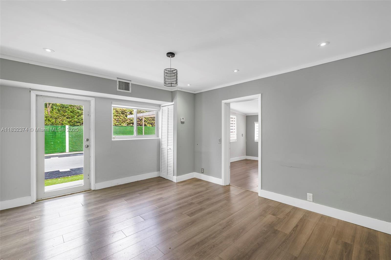 340 Southwest 25th Road Miami, FL 33129 - Photo 36 of 42 a view of an empty room with wooden floor and a window