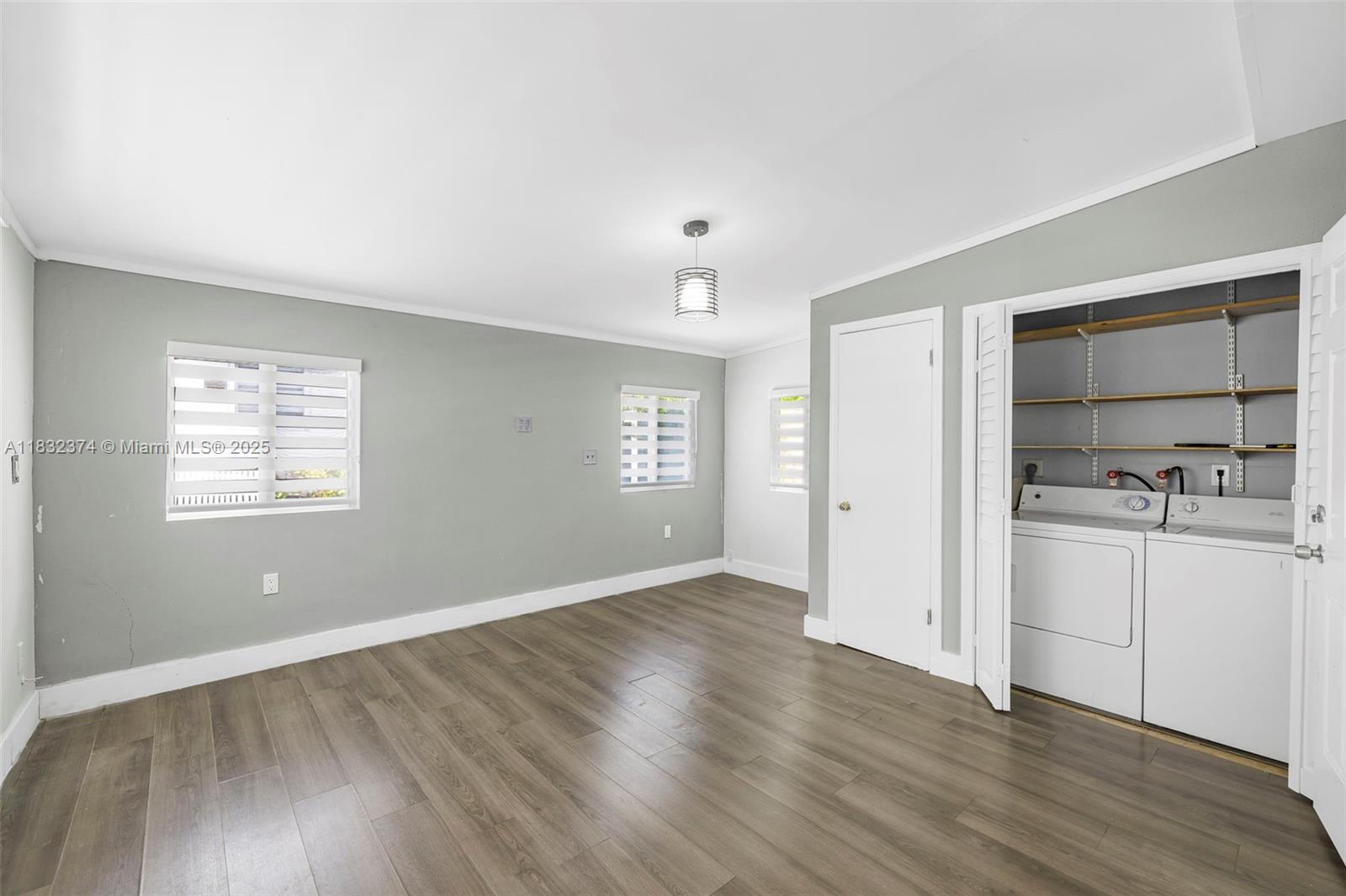 340 Southwest 25th Road Miami, FL 33129 - Photo 37 of 42 an empty room with wooden floor and windows