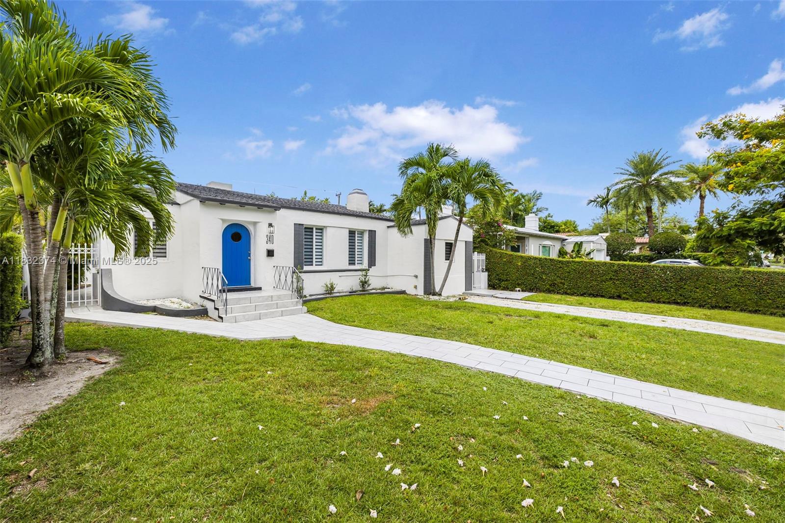 340 Southwest 25th Road Miami, FL 33129 - Photo 7 of 42 a view of a house with a big yard and palm trees