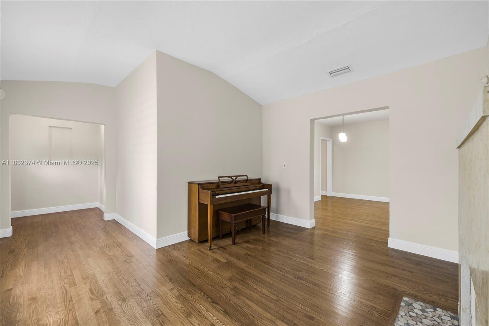 340 Southwest 25th Road Miami, FL 33129 - Photo 8 of 42 an empty room with wooden floor and furniture