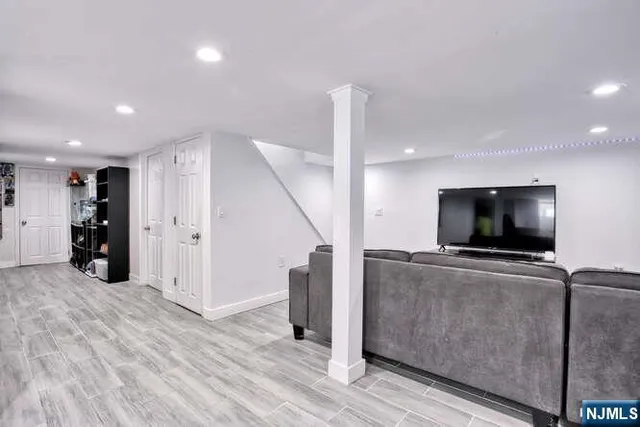 a view of a livingroom with furniture and a flat screen tv