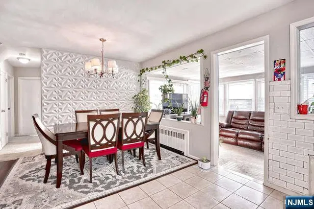 a dining room with furniture and chandelier