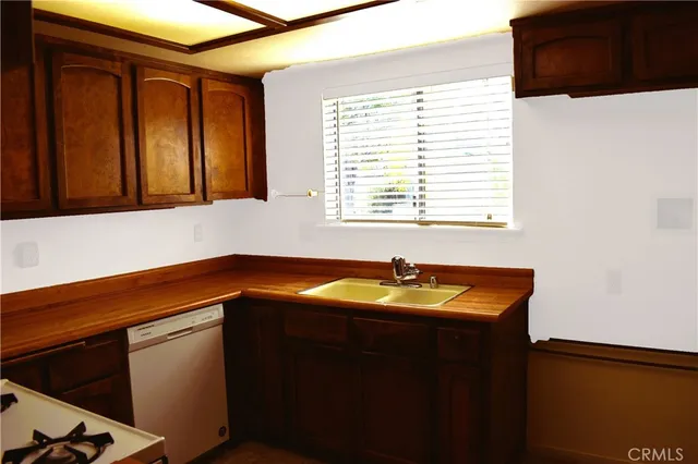 a kitchen with blue cabinets and sink