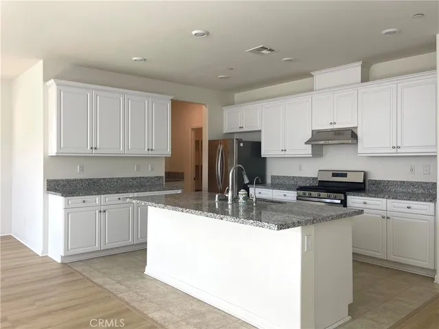 a bathroom with a toilet sink vanity and mirror