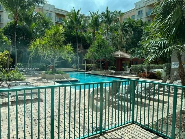 a view of a brick house with a small yard and a trees