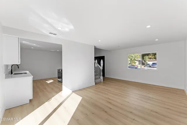 a view of an empty room with a sink