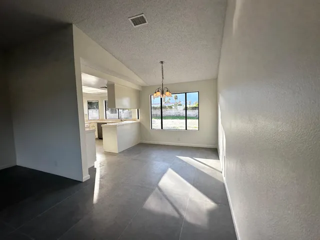 a view of a room with wooden floor and windows