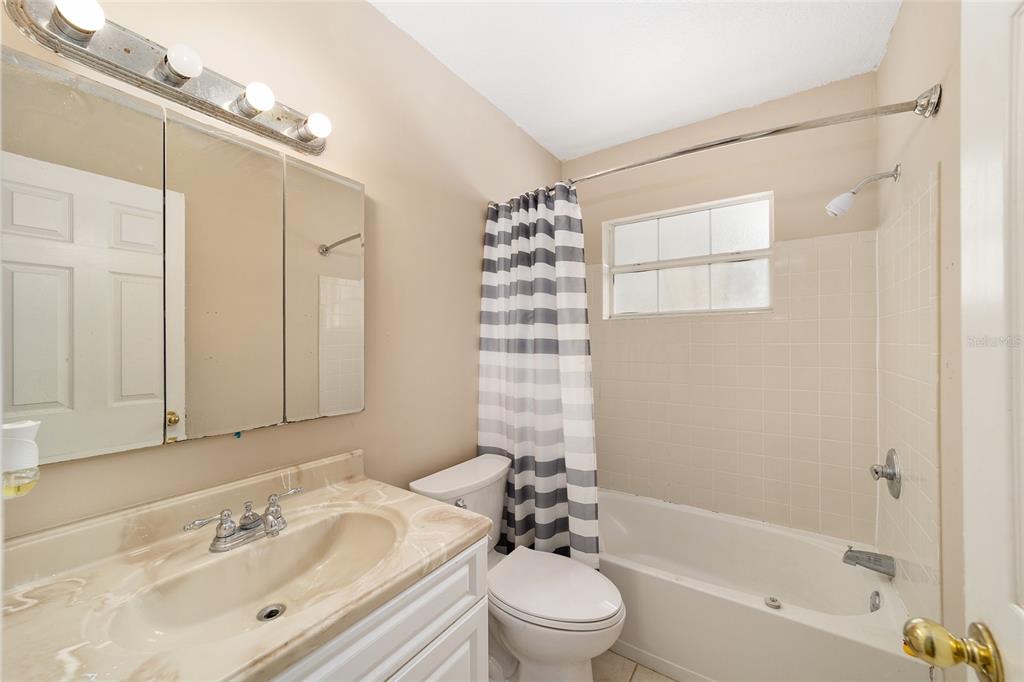 20934 3rd Avenue Dunnellon, FL 34431 - Photo 18 of 33 a bathroom with a bathtub shower sink vanity mirror and toilet