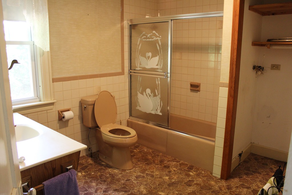 232 Gates Pond Road Berlin, MA 01503 - Photo 16 of 25 a bathroom with a granite countertop toilet a sink and a shower