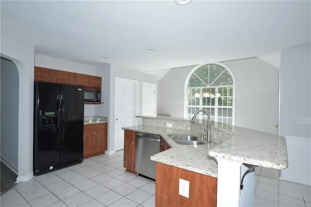 a kitchen with a sink a counter top space and stainless steel appliances