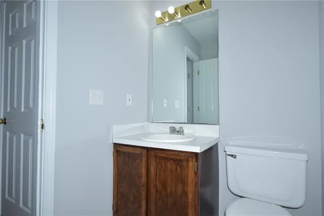 a bathroom with a sink vanity and toilet
