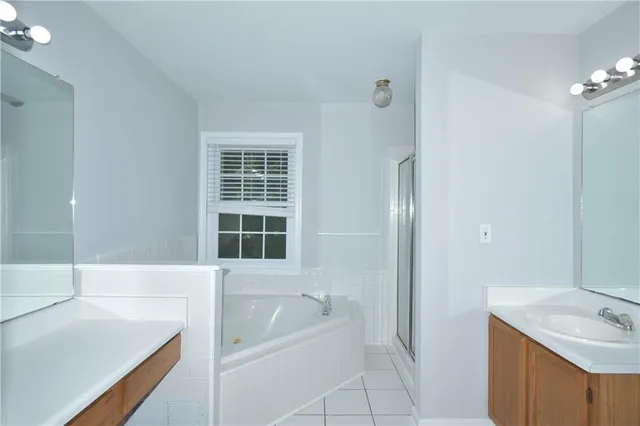 a bathroom with a tub sink and a shower