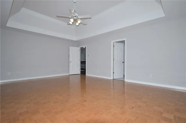 an empty room with fan and entrance