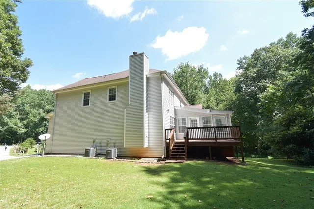 a house view with a sitting space and garden