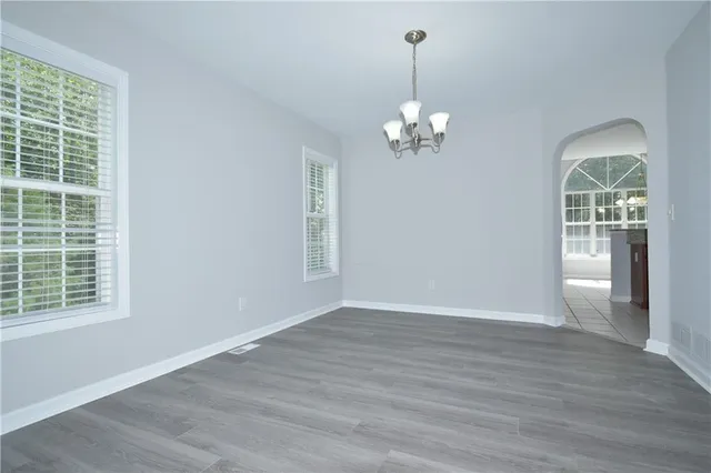 a view of livingroom with chandelier fan and wooden floor