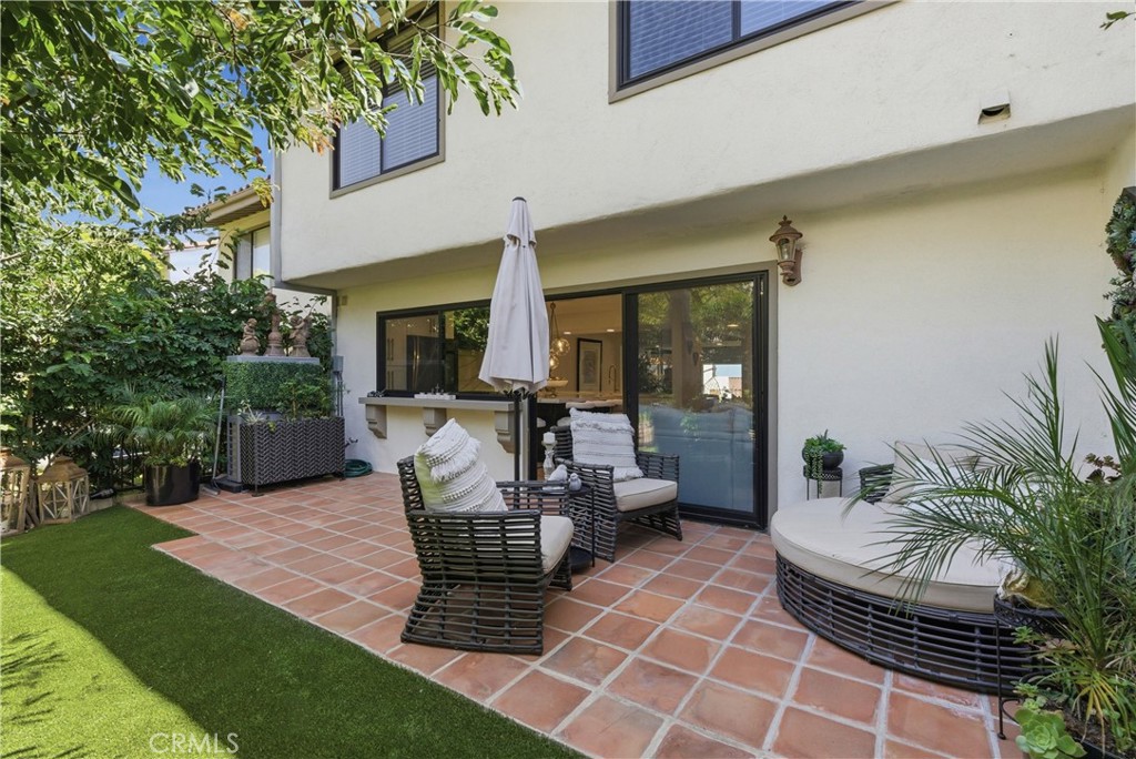 23281 Atlantis Way Dana Point, CA 92629 - Photo 57 of 81 a view of a patio with table and chairs potted plants and a large tree
