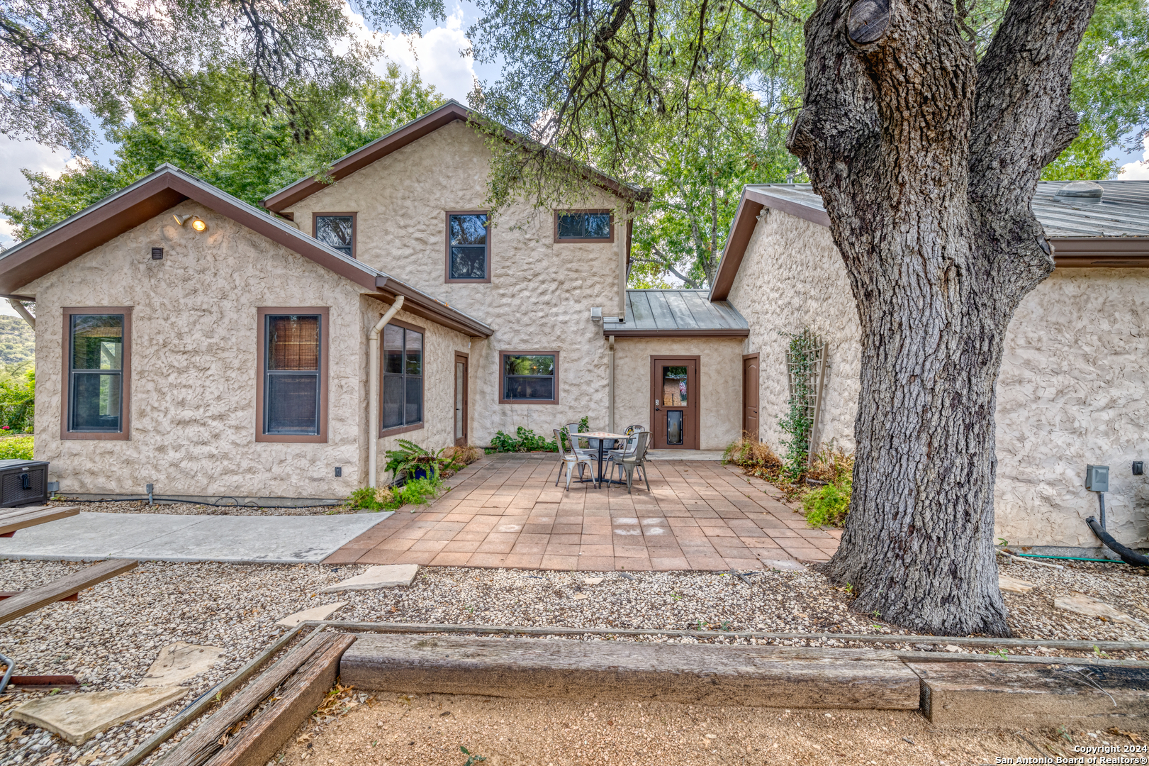 1242 River Road Concan, TX 78838 - Photo 29 of 42 a front view of a house with yard tree and outdoor seating