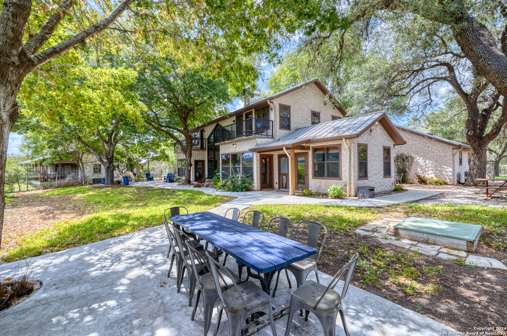 1242 River Road Concan, TX 78838 - Photo 32 of 42 a view of a house with swimming pool and a yard